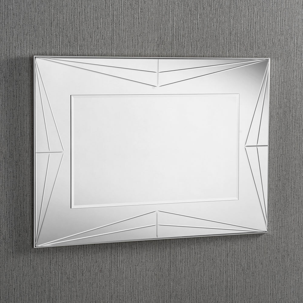 A rectangular all-mirror with a decorative silver frame. The frame is made up of intersecting lines and shapes, creating a geometric pattern. The mirror itself is clear and reflective. Landscape orientation.
