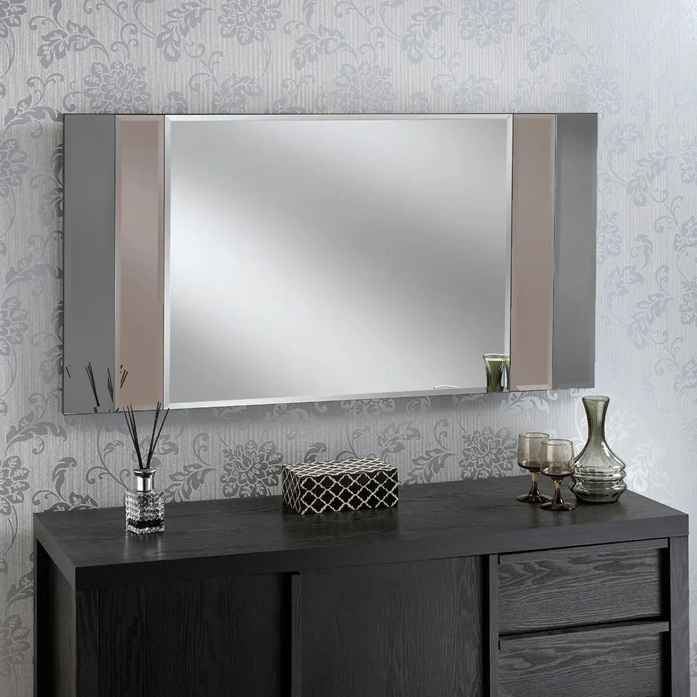 Large, black framed beveled wall mirror with vertical grey & bronze dividers, above a dark wood vanity.