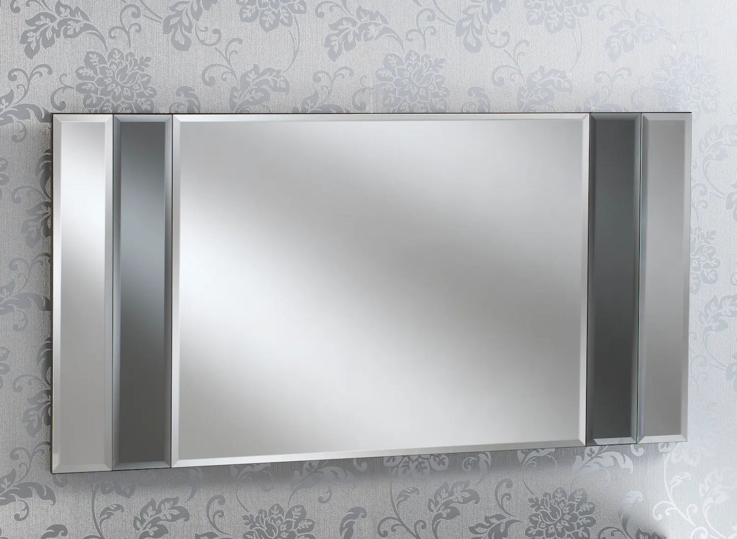 Large rectangular wall mirror with dark grey vertical accents against a grey floral wallpaper.