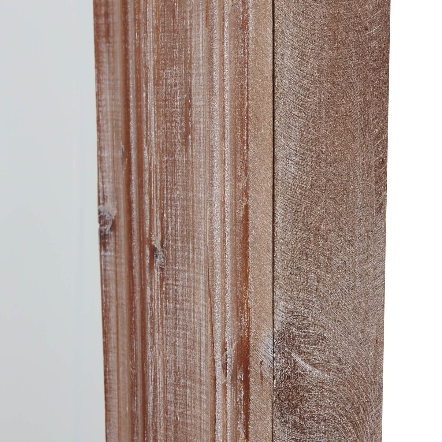 Close-up of light-brown wooden paneling with visible wood grain and a distressed, whitish finish.