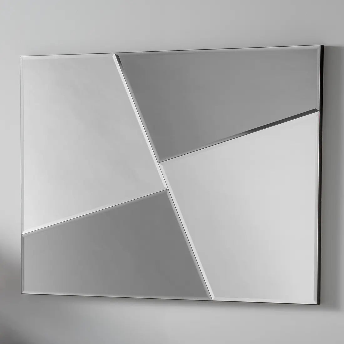 Geometric wall mirror with grey and silver reflective mirror panels.