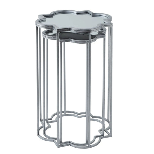 Stackable, silver-toned, decorative end tables with mirrored tops and a quatrefoil geometric design.